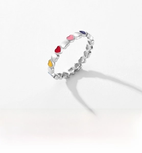 Macro detail of S925 sterling silver ring with colorful enamel heart-shaped patterns