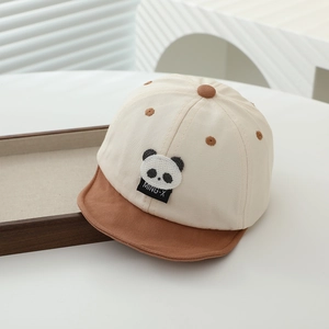 Détail d'une casquette bébé panda en coton avec broderie fine et visière marron