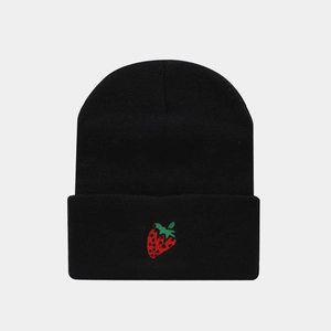 Close-up of strawberry embroidery on black knit beanie with premium textured finish