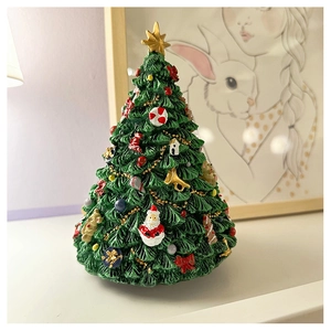 Detailed close-up of a rotating Christmas tree music box with festive holiday ornaments