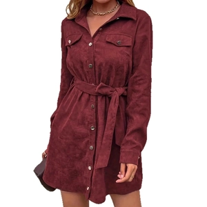 Close-up of burgundy corduroy texture and button detail on long sleeve shirt dress