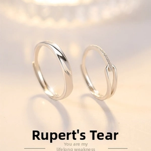 Detail of silver couple rings with polished finish and cubic zirconia inlay