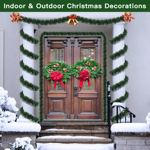 Deep green Christmas tinsel garland with red bows and gold bells on a front porch