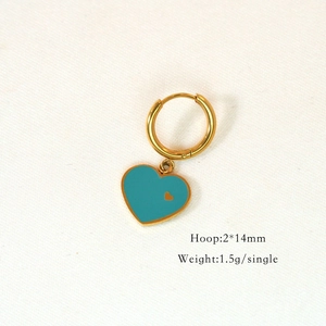 Macro detail of golden hoop earring with a vibrant blue heart pendant and size specs