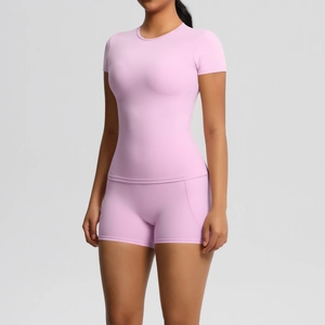Close-up of pink short-sleeve yoga top and high-waist sports shorts with ergonomic seams