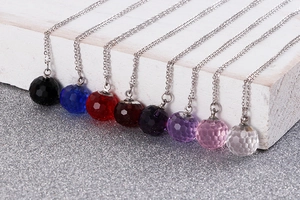 Detail view of faceted crystal ball pendants in eight colors with silver steel chain