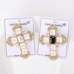 Detailed view of two Baroque cross brooches with gold plating and rhinestones