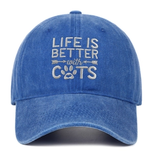 Detail of LIFE IS BETTER with CATS embroidery on washed blue cotton baseball cap
