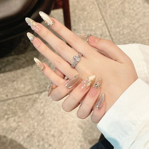 Champagne cat eye press-on nails with luxury butterfly and rhinestone 3D accents