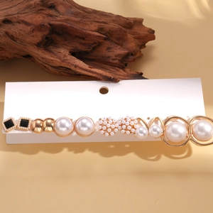 Detailed set of 12 mixed pearl and gold stud earrings displayed on white cardboard