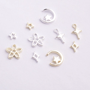 Close-up of assorted silver and gold star charms for DIY nail art and jewelry