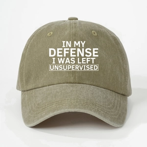 Detailed close-up of khaki green washed cotton baseball cap with white printed text