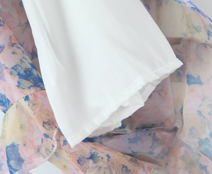 Detail of floral printed fabric with white lining and precise machine stitching