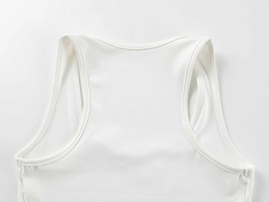 Close-up of white high-stretch ribbed fabric showing stitching and square neckline detail