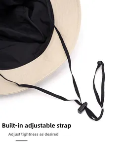 Detail of sun hat showing adjustable windproof drawstring and two-tone beige fabric