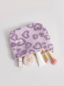 Soft purple plush heart pattern cosmetic bag with makeup brushes and lipstick inside
