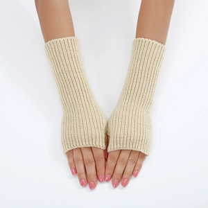 Close-up of beige knitted fingerless gloves showing detailed ribbed texture on wrist