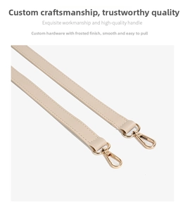 Detailed view of cream leather shoulder strap with matte gold lobster clasp and stitching