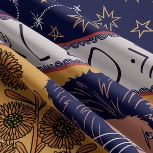 Macro shot of assorted tapestry fabric textures showing celestial and floral prints