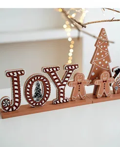 Detailed view of wood JOY Christmas ornament with gingerbread man and candy cane stripes