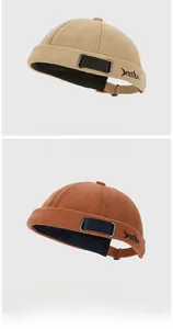 Detail of adjustable strap and XEENA embroidery on beige and caramel miki hats
