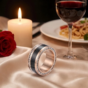 Detail of rose gold titanium ring with black carbon fiber and double-row sparkling zircons