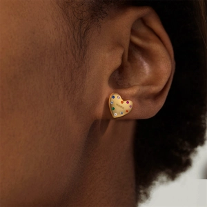 Close-up of a heart earring in golden finish with colorful stones and mama engraving