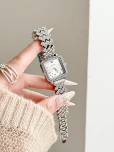 Detail showing square dial watch with diamond bezel and geometric rhinestone bracelet