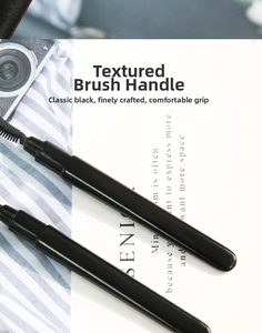Close-up of sleek black silicone eyelash brush handles on a modern aesthetic background