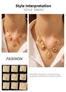 Detail view of gold charm necklaces with diverse elements like shells and pearls