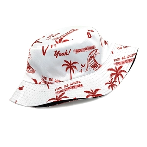 Detail view of cotton sun hat with red palm tree patterns and summer wave graphics