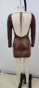 Detail of sequin long sleeve mini dress featuring a backless design with tie-up straps