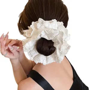 Back view of oversized white lace scrunchie with floral embroidery for bun hairstyles