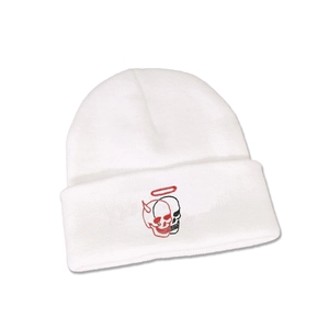 Close-up of a white knit beanie featuring creative red and black skull embroidery