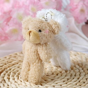 Detail of plush teddy bear charms in khaki and white with silver beaded chains