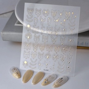Detail of 5D gold embossed nail stickers with jewelry patterns and finished nail samples