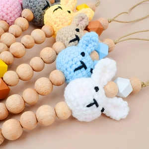 Handmade crochet bunny pacifier clip set with natural beech wood beads in soft colors
