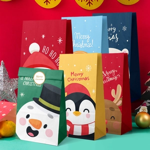Detailed view of colorful Christmas paper gift bags with Santa and snowman patterns
