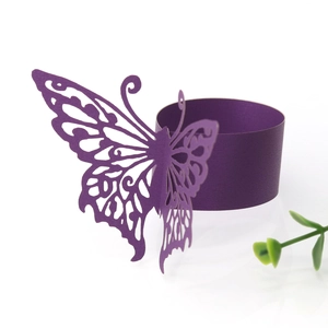 Detail of purple laser-cut butterfly paper napkin ring for elegant wedding table settings