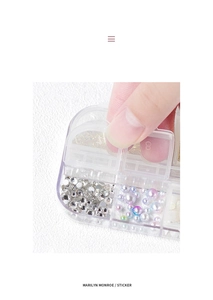 Macro shot of 8-compartment nail art storage box with pearls and faceted crystals