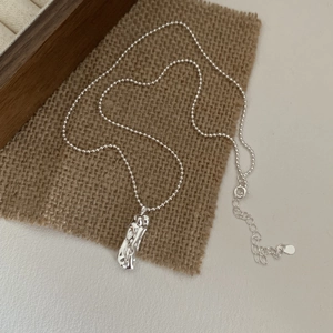 S925 sterling silver geometric pendant necklace with molten lava texture on burlap