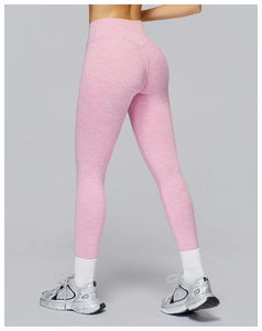 Detail of high waisted yoga leggings in heathered pink with tummy control and lifting seams