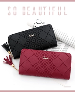 Detail of long zipper wallets in black and burgundy with leather texture and tassels