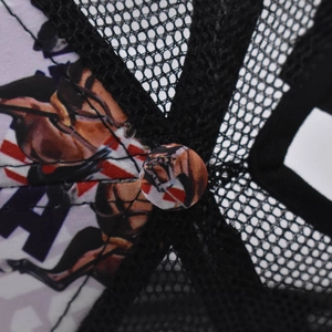 Macro detail of ponytail baseball cap featuring horse print and British flag pattern