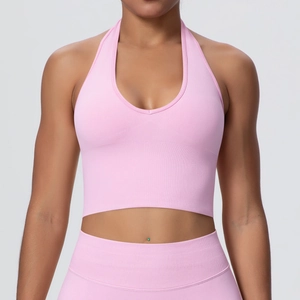 Front view of pink halter neck sports bra and high waist leggings yoga set on a model