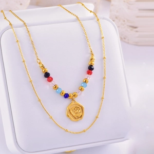 Double-layered necklace with colorful beads and a golden rose flower pendant detail