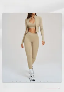 Close-up of three-piece fitness set including zip jacket, sports bra and high-waist leggings