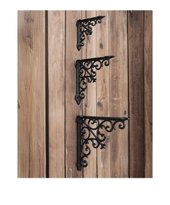Three set vintage European cast iron brackets with hollow patterns on wooden wall