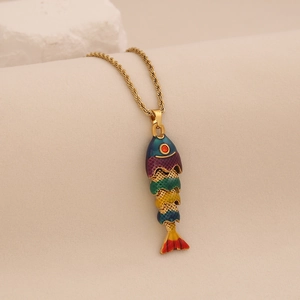 Detailed close-up of a colorful jointed fish pendant with a golden twist chain and red eye