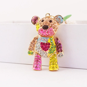 Colorful rhinestone-encrusted bear keychain with heart pattern on a white background